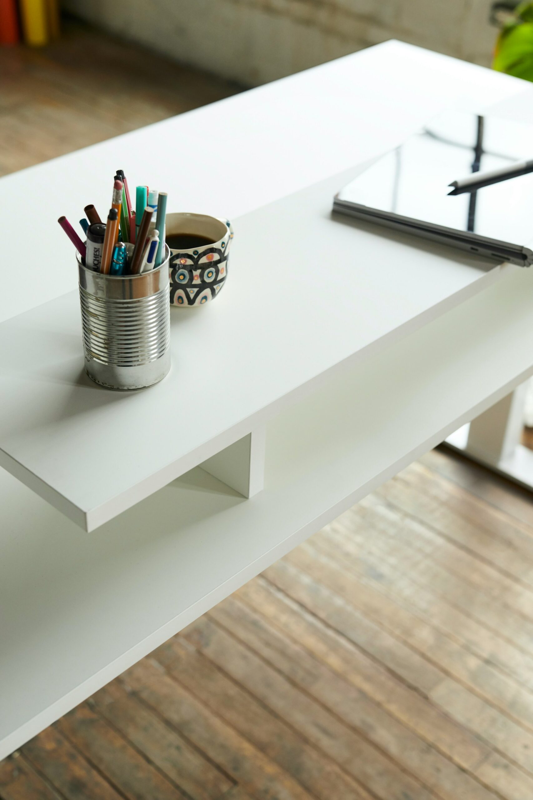 Minimalist desk with pencils, tablet and a cup of coffee